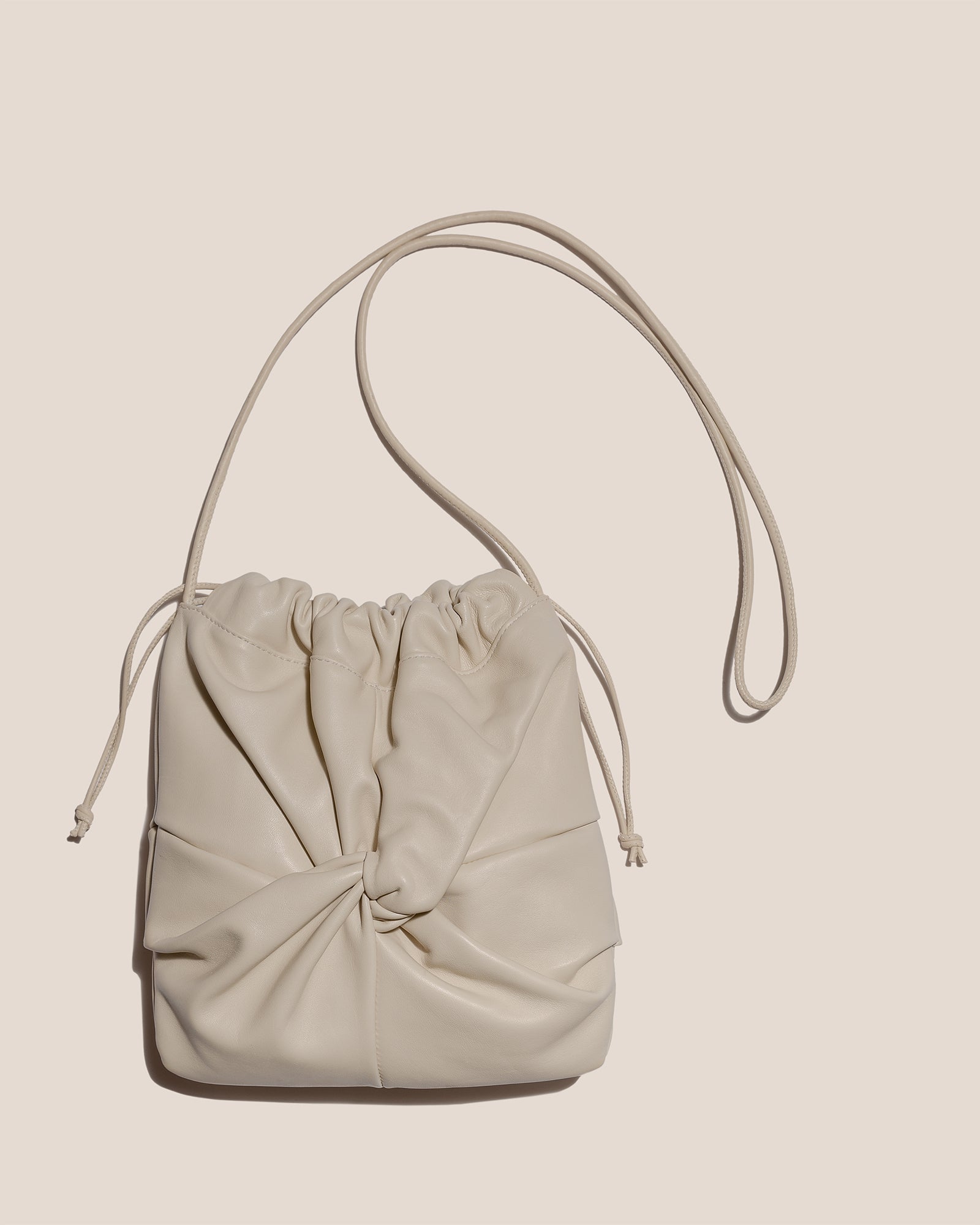 HEREU - 'Ronet' Flat crossbody bag with twisted detail on front and back. # HEREU #PF22