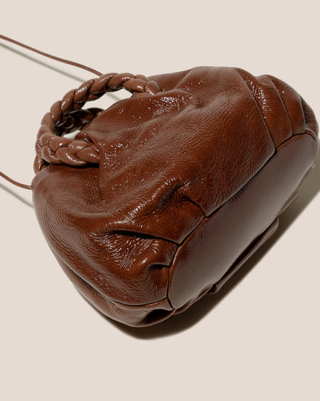BOMBON CRINKLED GLOSSY - Plaited-handle Leather Handbag