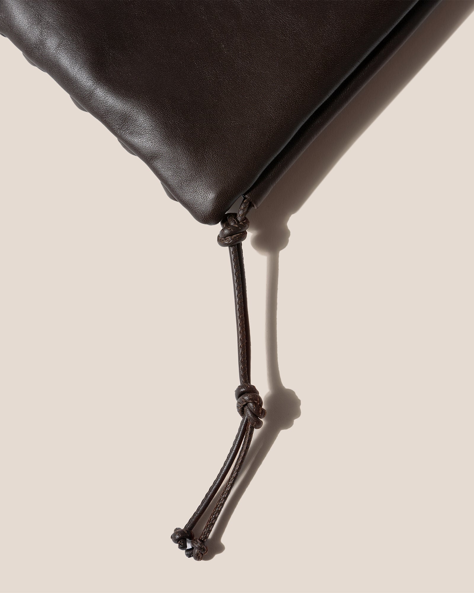 HEREU - 'Ronet' Flat crossbody bag with twisted detail on front and back. # HEREU #PF22